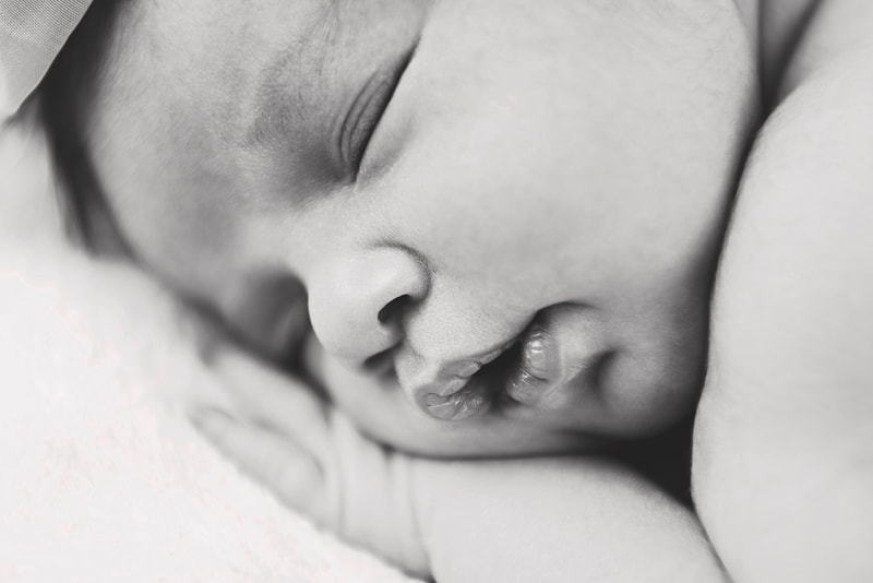 black and white close up photo of a newborn baby girl 